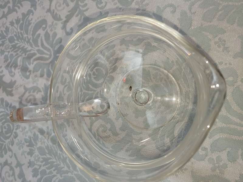 A GLASS SOUCE JUG SOLD AS IS