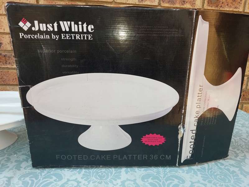 A JUST WHITE PORCELAIN EETRITE FOOTED CAKE STAND AND CUTTER