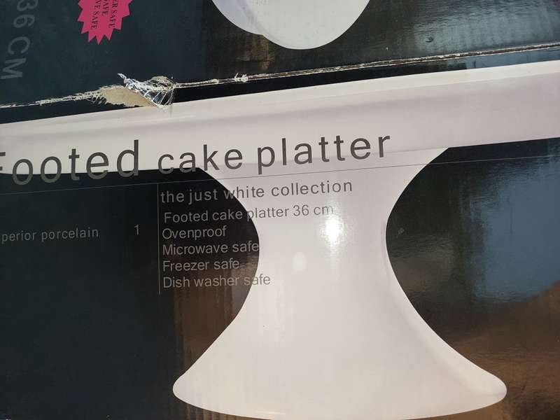 A JUST WHITE PORCELAIN EETRITE FOOTED CAKE STAND AND CUTTER
