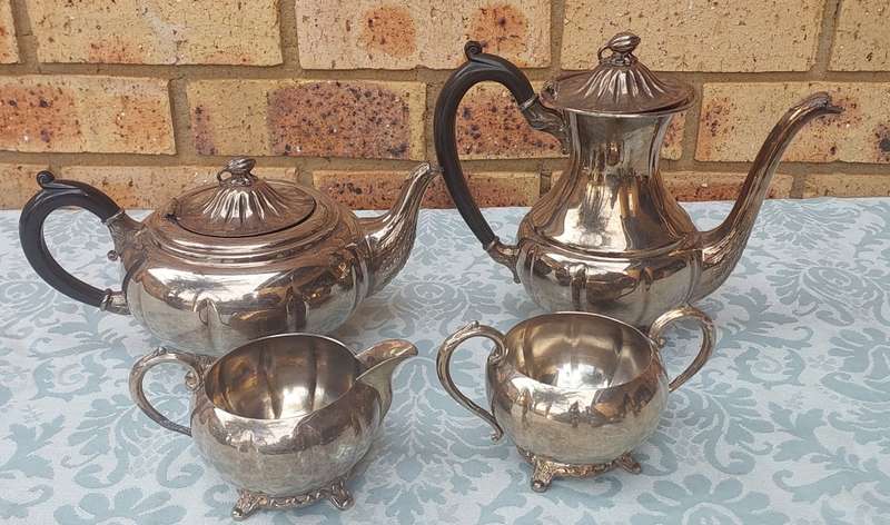 AN ANTIQUE TEA JUG SET SOLD AS IS