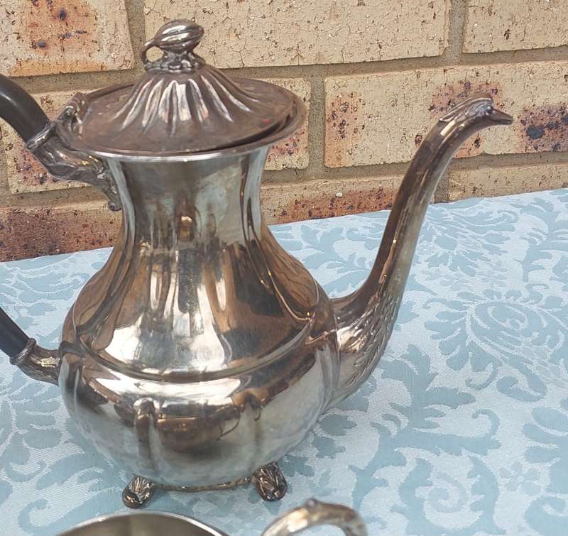 AN ANTIQUE TEA JUG SET SOLD AS IS