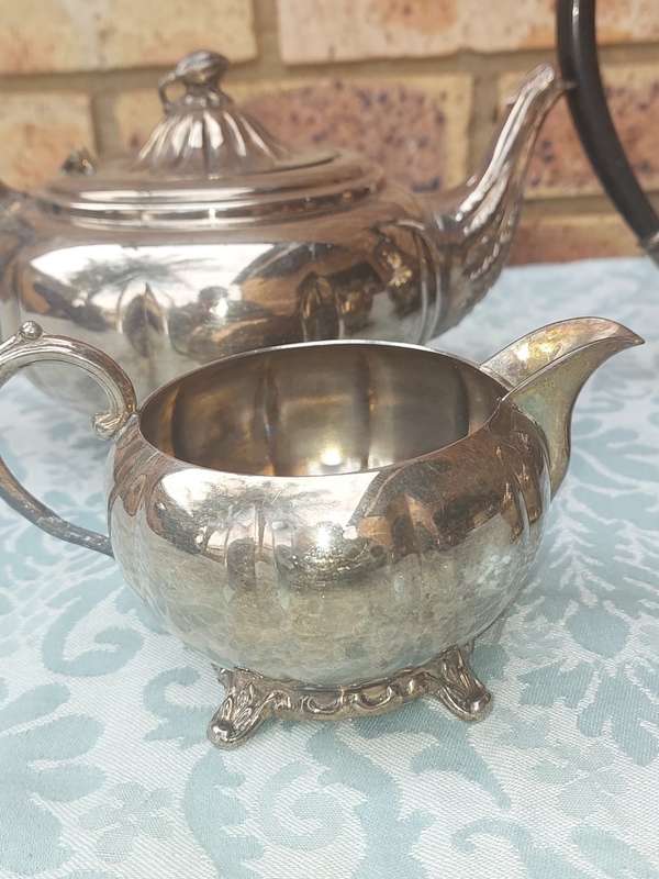AN ANTIQUE TEA JUG SET SOLD AS IS