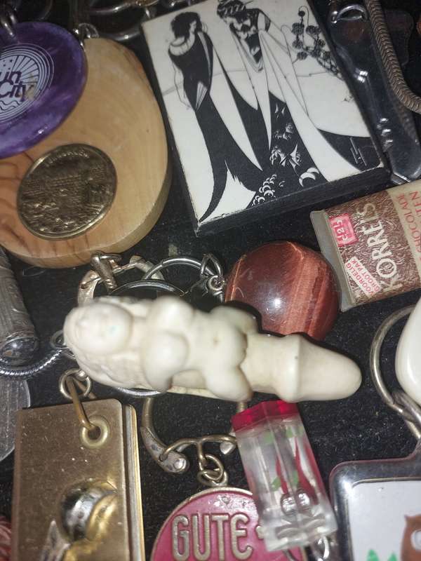A bulk collection of erotica key rings sold  as is