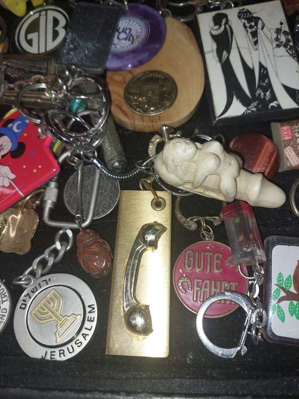 A bulk collection of erotica key rings sold  as is