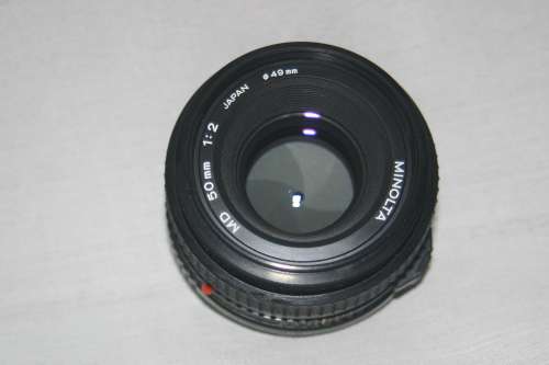 MINOLTA  MD  50 mm  1:2.   49 mm dia. FILM CAMERA LENSE.
