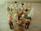 Collection of 24 Miniture Liquour bottles (contents removed)