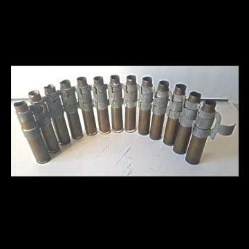 A Peace Of  12.7 mm. (0.5 inch) Browning Machine Gun Belt With Twelve Shell Casings In It.