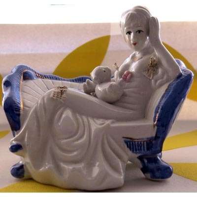 Reclining lady with cat figurine