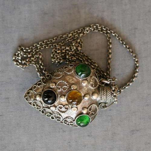 Exotic vial pendant on a chain