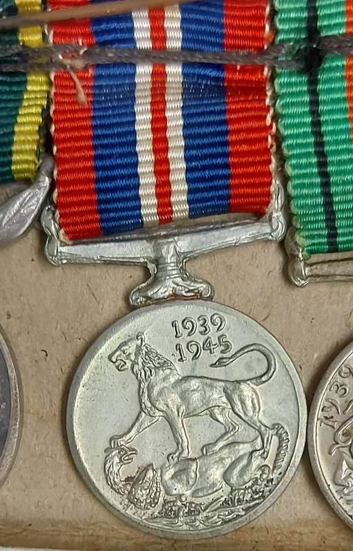 A SET OF MINIATURE WW2 MEDALS FOR CAPTAIN LC CROSS
