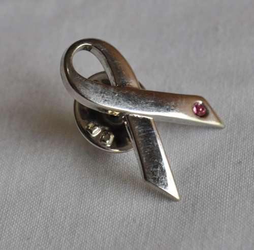 Silver tone ribbon lapel pin with pink stone