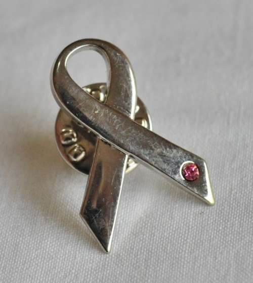 Silver tone ribbon lapel pin with pink stone