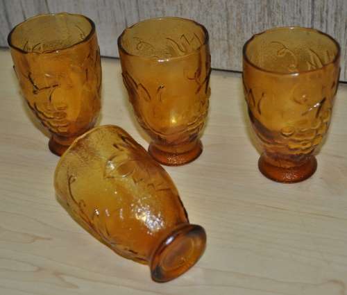 Vintage mid-century embossed amber glass decanter with four glasses