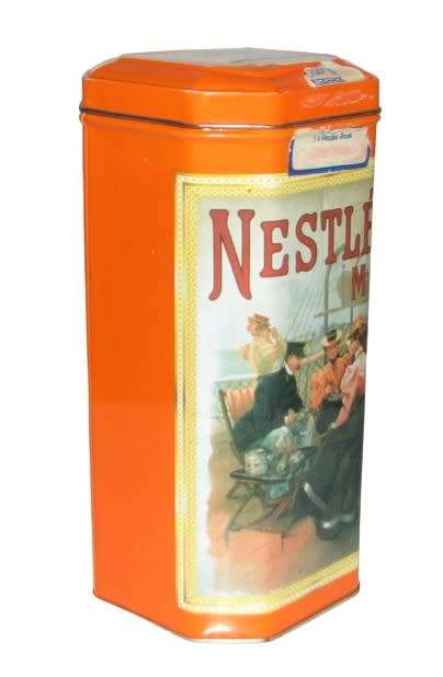 Vintage, collectible Nestlé Treat Tin decorated with vintage advertising