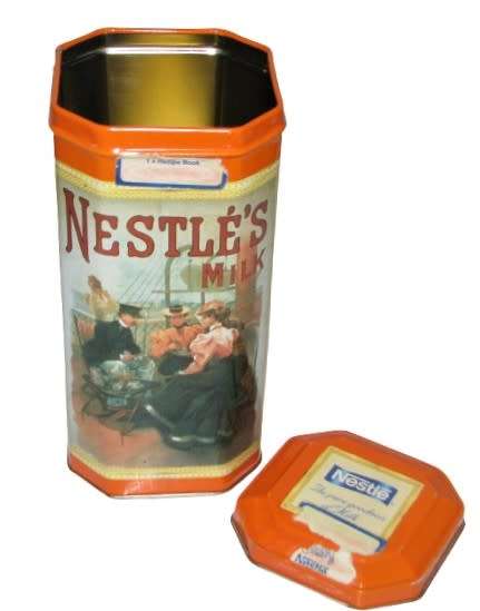 Vintage, collectible Nestlé Treat Tin decorated with vintage advertising
