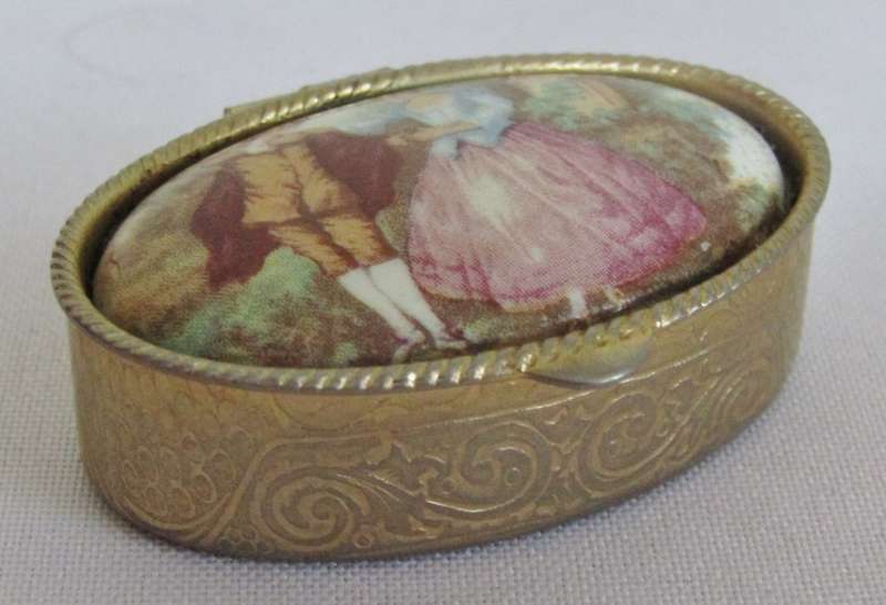 Vintage gold tone Rococo style pill box with Fragonard Courting Couple Decoration
