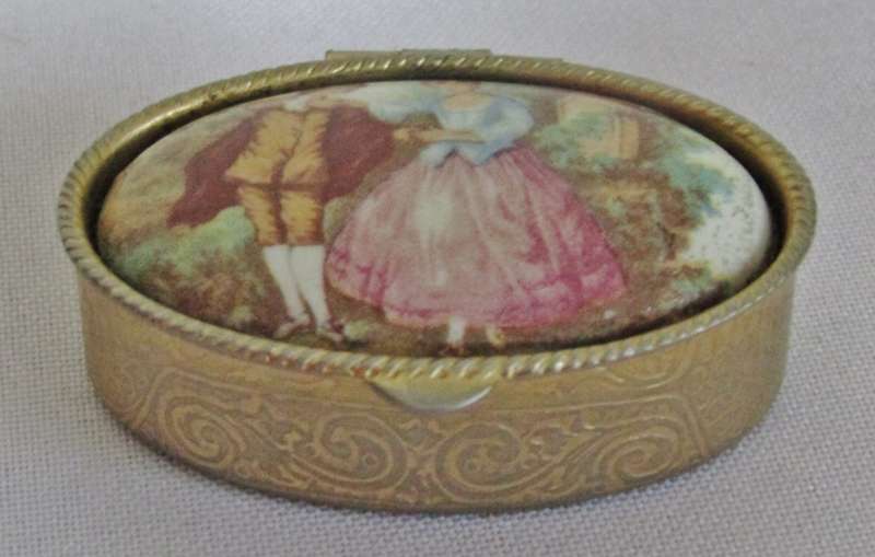 Vintage gold tone Rococo style pill box with Fragonard Courting Couple Decoration