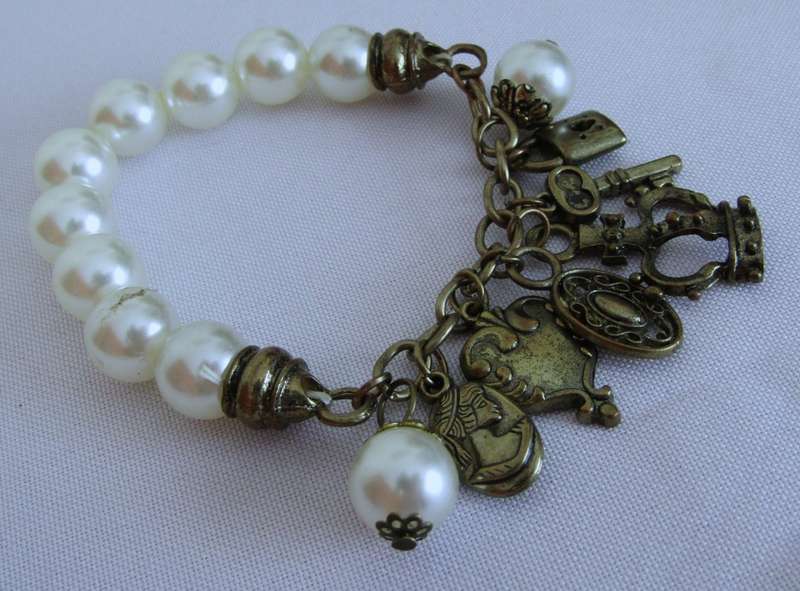 Vintage faux pearl stretch bracelet with brass tone charms