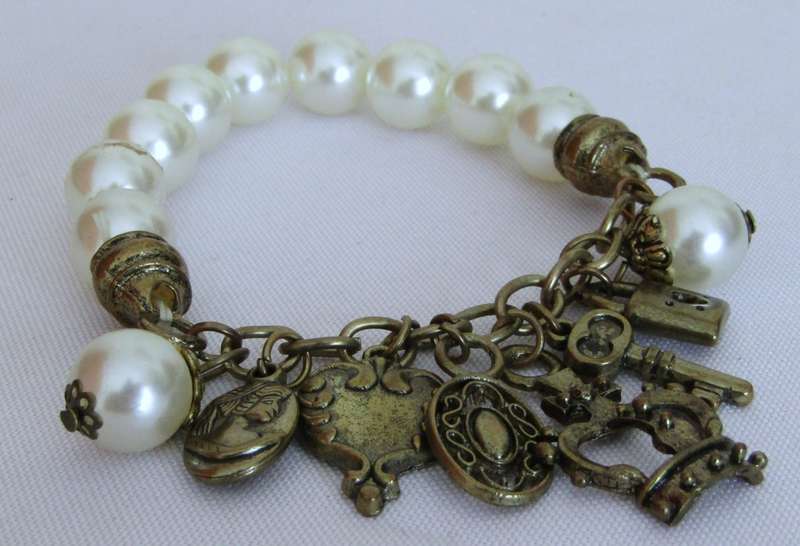 Vintage faux pearl stretch bracelet with brass tone charms