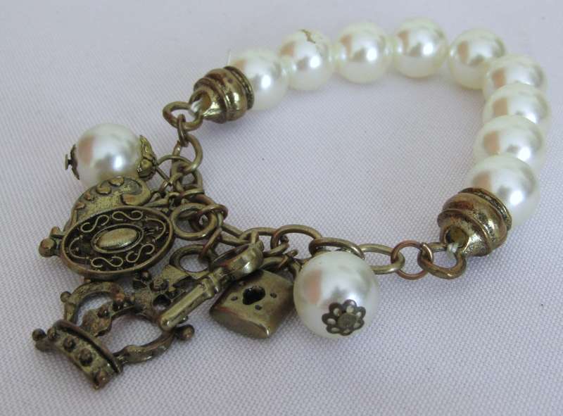 Vintage faux pearl stretch bracelet with brass tone charms