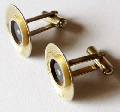 Vintage round gold tone and black cufflinks with small diamond-shaped stone