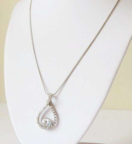 A tear drop pendant with big stone and silver tone chain