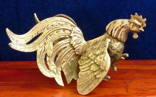 A vintage pair of silver plated brass fighting roosters ornaments or bookends