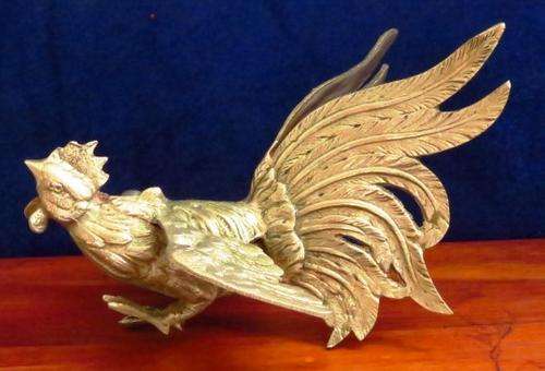 A vintage pair of silver plated brass fighting roosters ornaments or bookends