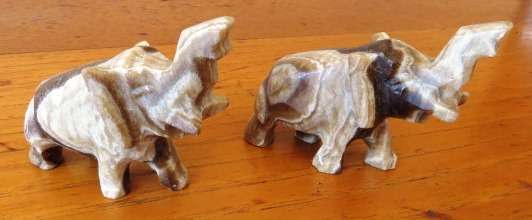 A pair of vintage hand carved marble onyx elephant figurines