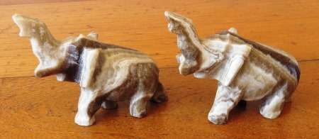A pair of vintage hand carved marble onyx elephant figurines