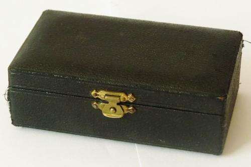 Small antique cast iron pressure gauge with brass plated trim in original case with 3 needles