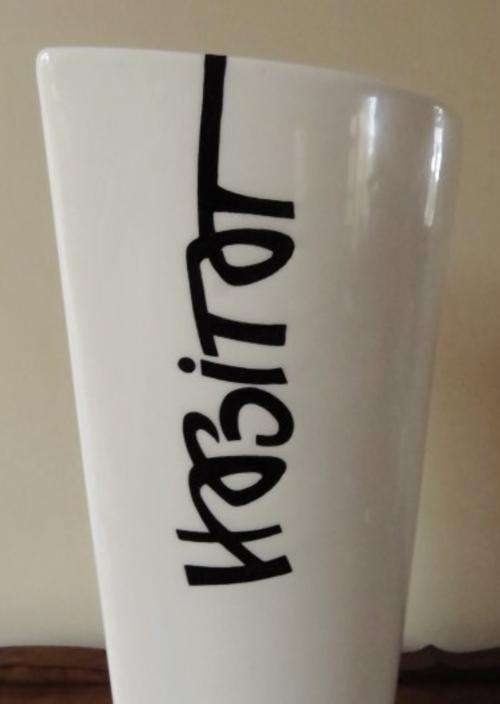 Large vase with white glaze and the word Habitat in black from the studio of Mariette Lange