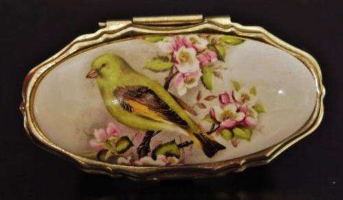 Vintage gold tone and porcelain mirrored lipstick holder decorated with a bird