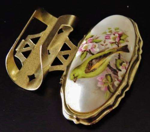 Vintage gold tone and porcelain mirrored lipstick holder decorated with a bird 