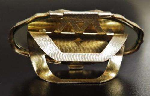 Vintage gold tone and porcelain mirrored lipstick holder decorated with a bird 