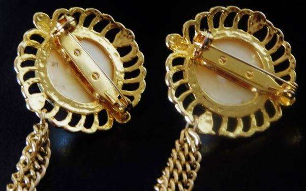 Vintage gold tone faux pearl double brooch pin connected with three chains