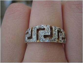 GREEK 9CT GOLD RING AND DIAMONDS.  DIAMONDS ARE SET IN WHITE GOLD.