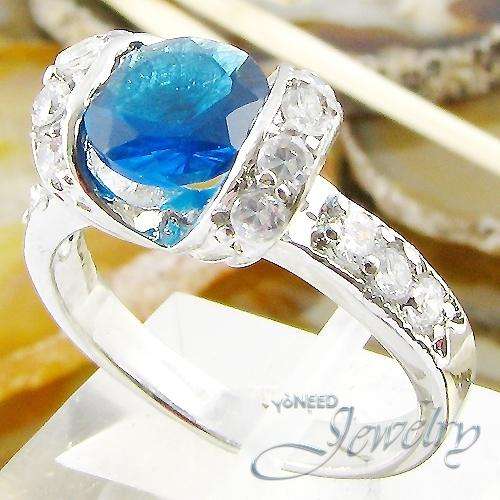 18K WHITE GOLD PLATED WITH 7MM ROYAL BLUE SAPPHIRE AND 12 TOPAZ ON FLANK
