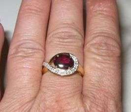 SOLID 9CT GOLD WITH A 6.7MM X 8.7MM MOZAMBIQUE GARNET AND VERY SMALL DIAMOND RING