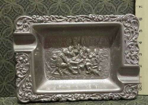 Embossed metal ashtray