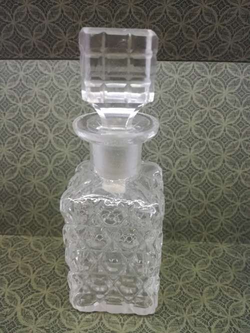 Glass perfume bottle with stopper. Small chip on the rim