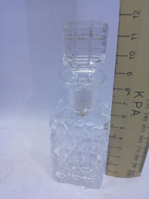 Glass perfume bottle with stopper. Small chip on the rim