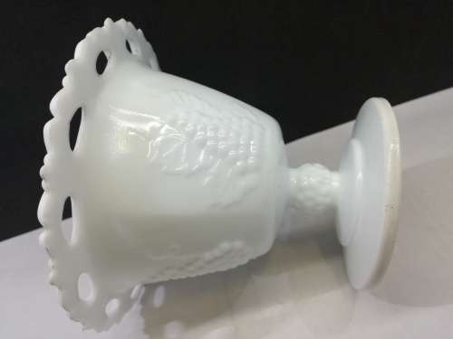 Footed milk glass vase