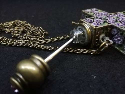 Beautiful vintage look cross with perfume bottle on long chain