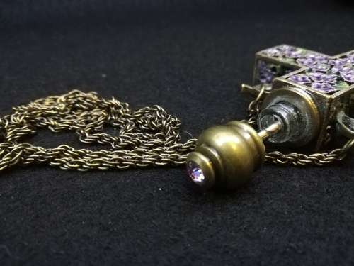 Beautiful vintage look cross with perfume bottle on long chain