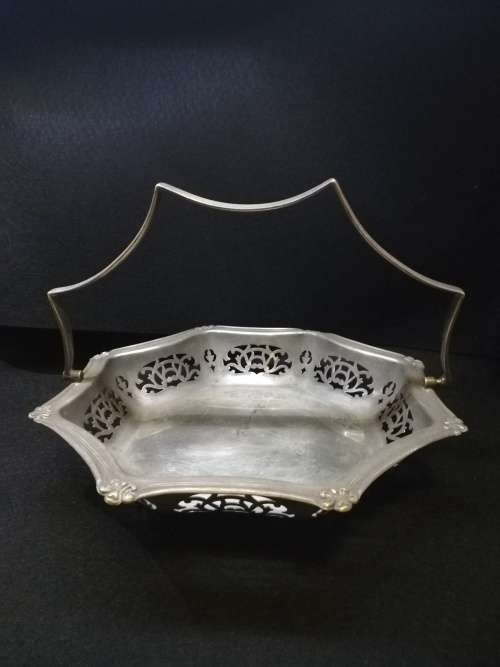 Ornate metal bowl with handle and feet