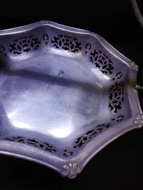 Ornate metal bowl with handle and feet