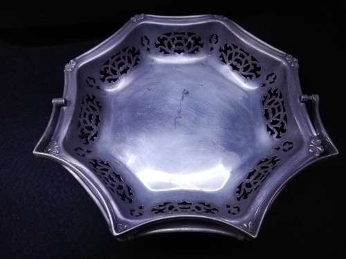 Ornate metal bowl with handle and feet