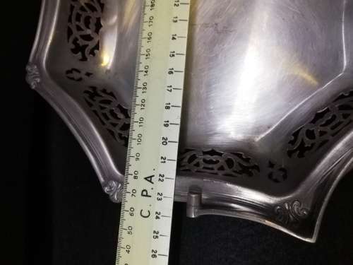 Ornate metal bowl with handle and feet