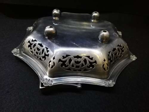 Ornate metal bowl with handle and feet